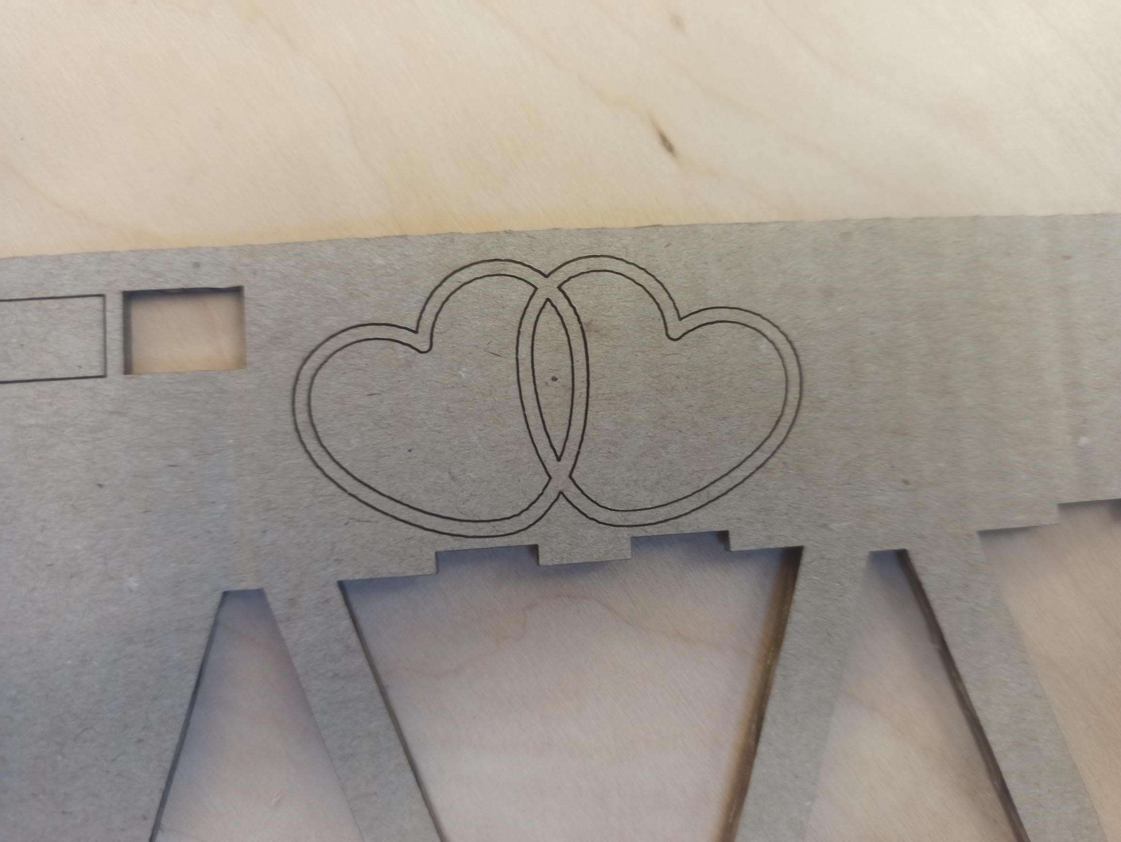 Two interlinked cardboard hearts